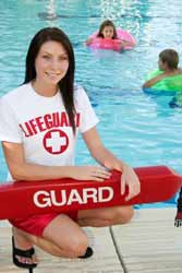 Summer Lifeguard Poses for Photo by Swimming Pool