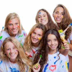 Summer Camp Counselor and Campers Show Off Painted Faces and T-Shirts